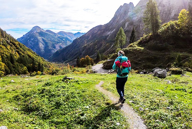 Woman trekking in the Italian Alps, during summer.