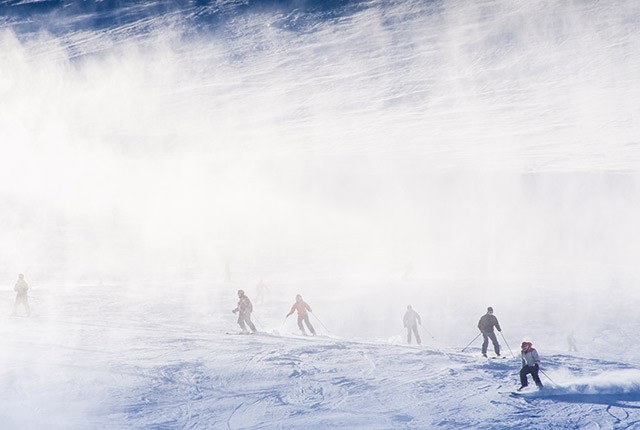 Skier sking in snow blowing